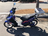 a blue scooter parked in a parking lot