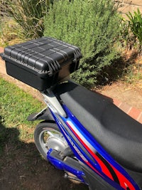 a motorcycle with a box on the back seat